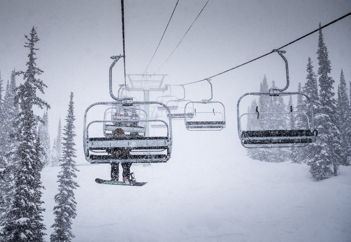 Chair lifts in the snow go up the mountain at Whitewater Ski Resort in the Kootenay Rockies