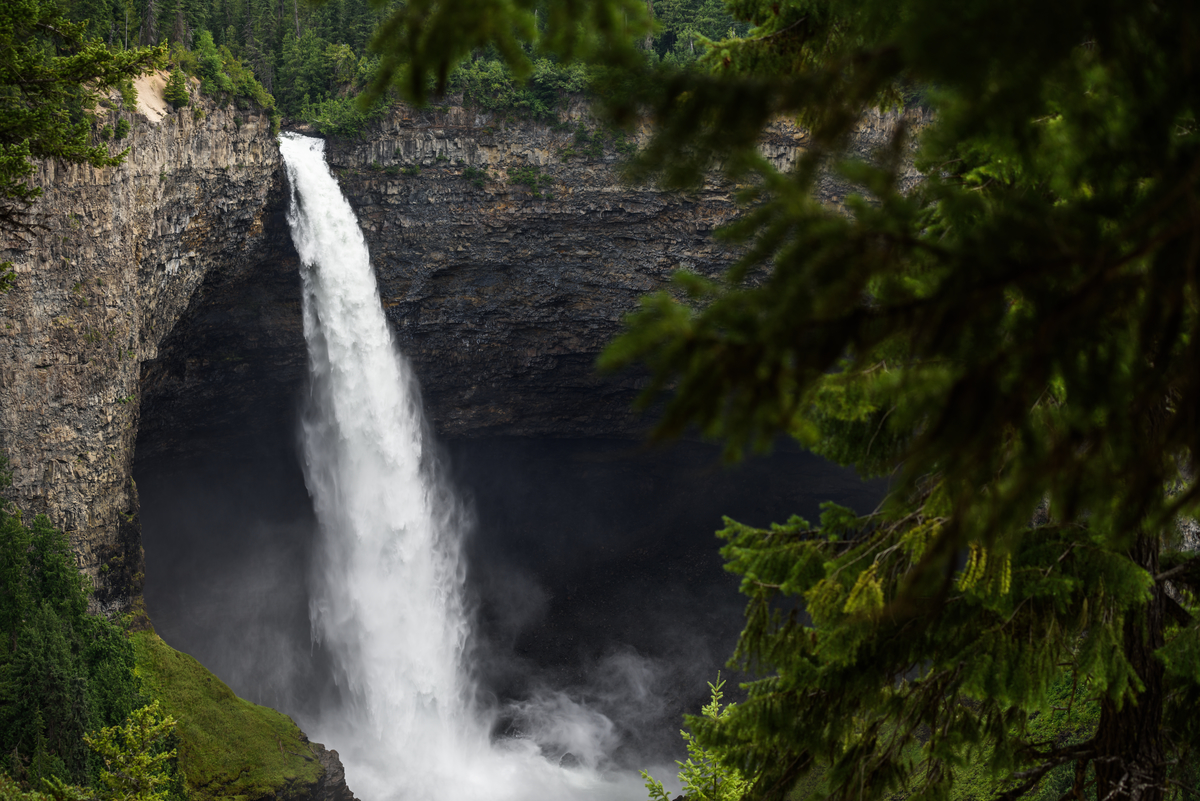Helmcken Falls at Wells Gray Provincial Park. The waterfall plunges down from a high ledge into the pool below.